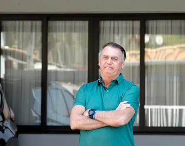 O ex-presidente brasileiro Jair Bolsonaro acena em sua residência em Brasília