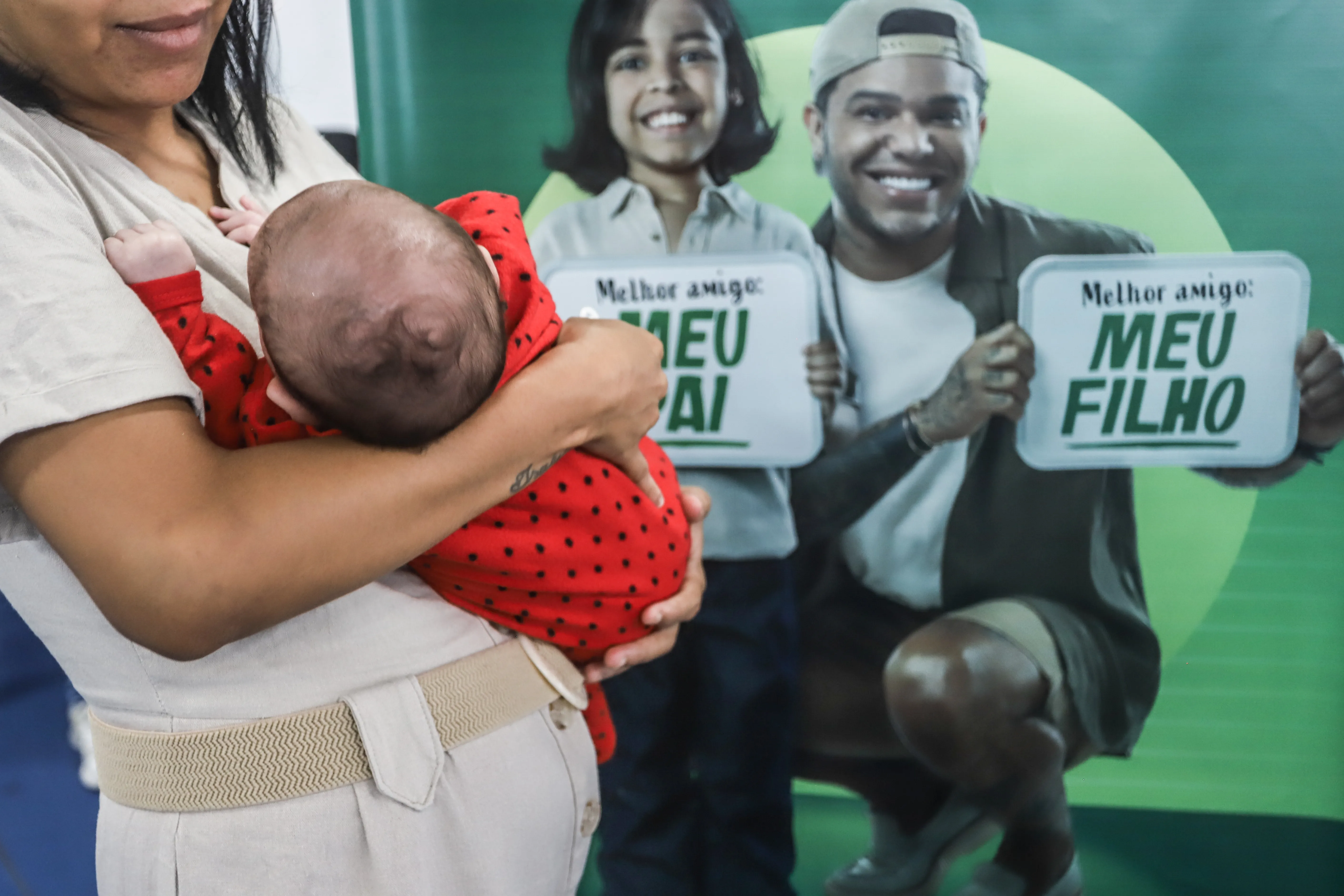 Mãe segurando bebê durante espera de exame de DNA na ação Cidadã na Arena Fonte Nova