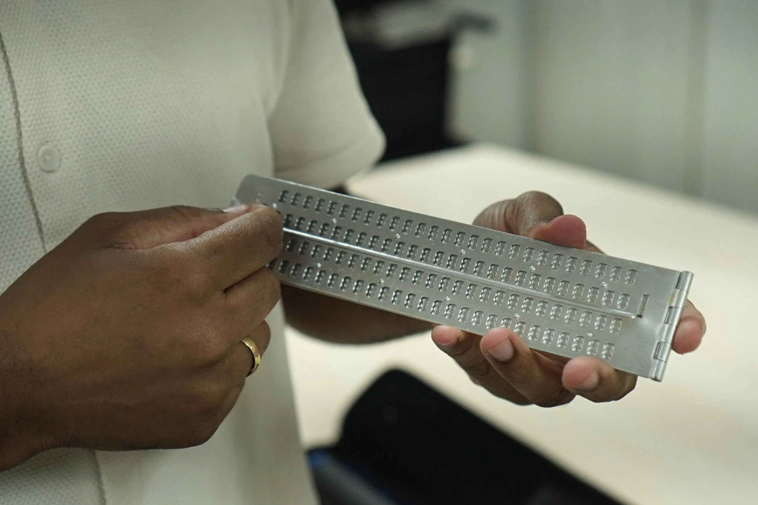 Na foto, uma linha braile. O insPossui uma fileira de células com pinos que sobe e desce para formar letras em braille em tempo real.